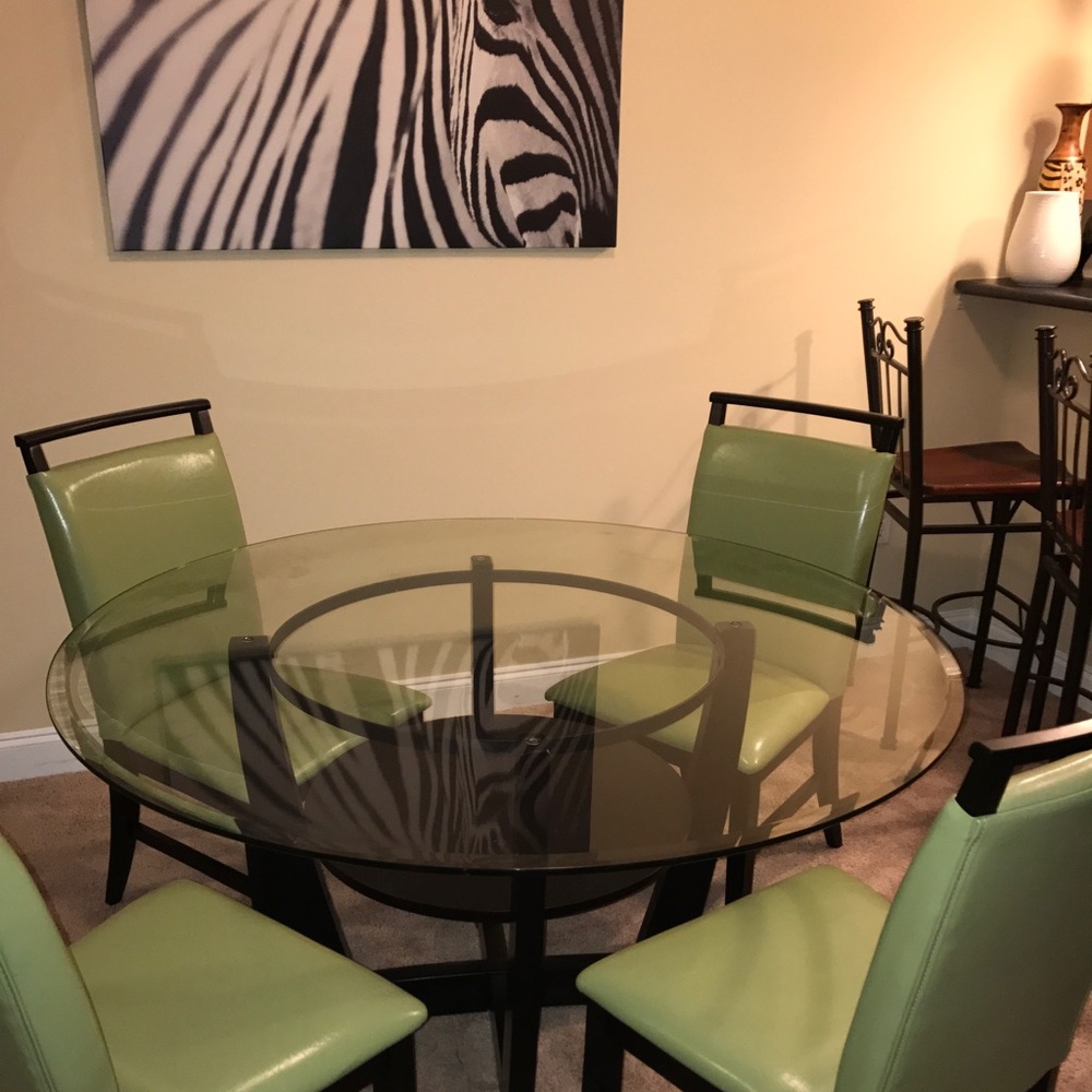 Glass table with green chairs